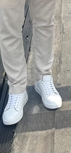 Customer's white Lufiano lace-up shoes worn with light trousers while standing outdoors.