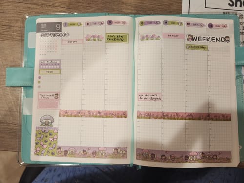 Reviewer's open Ultimate Subscription planner showing pages decorated with colorful character stickers and washi tape.