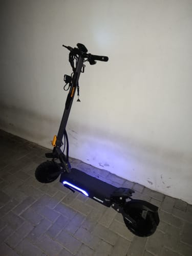 Customer's Ausom Gosoul 2 electric scooter standing indoors with glowing blue LED deck lights.