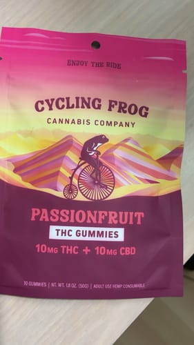 Customer's pink and orange packaging for Passionfruit THC gummies featuring a frog on a bicycle graphic.