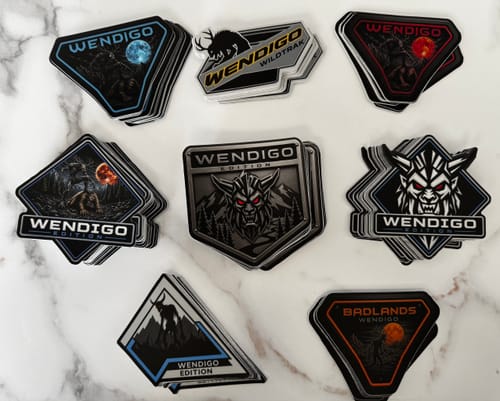 Customer's Secret Sticker Sale vinyl stickers, featuring various Wendigo designs in stacks on a white surface