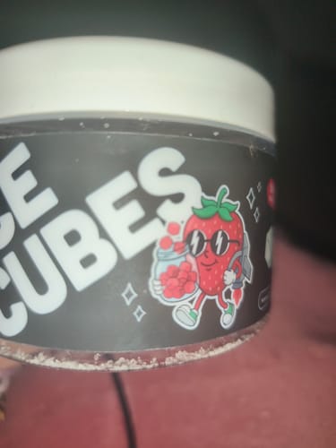 Customer's THC Space Cubes container with a cartoon strawberry wearing sunglasses on the label.